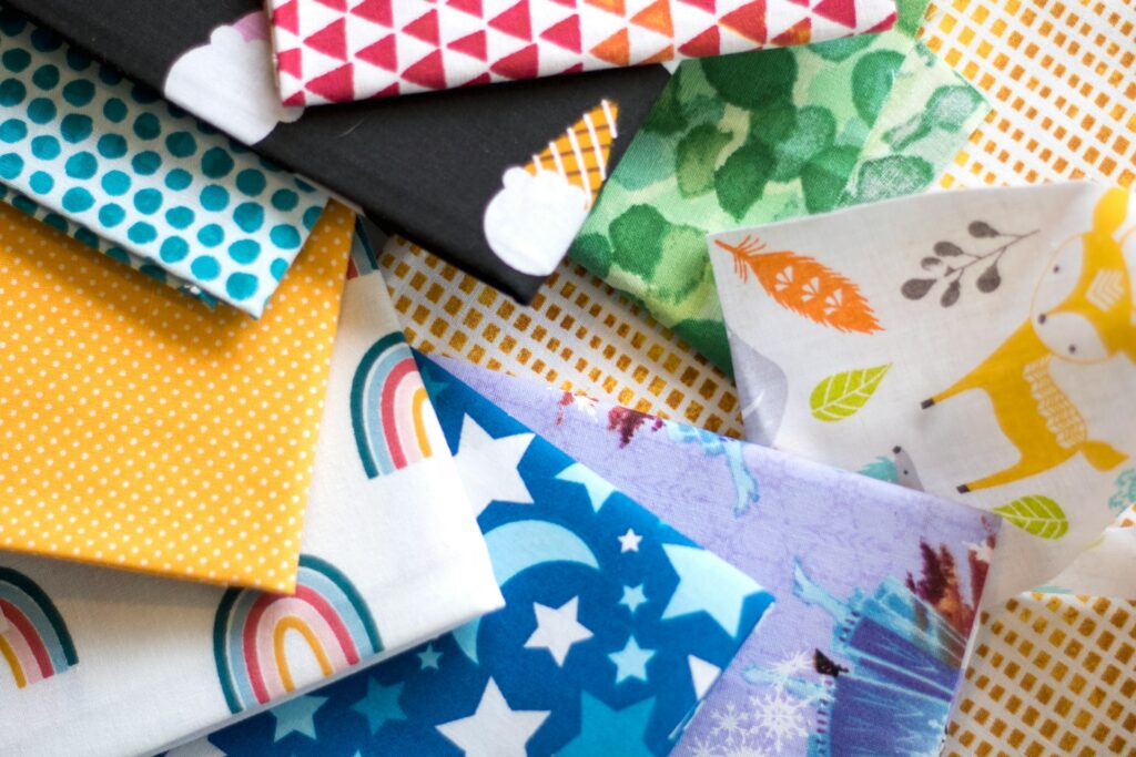 A pile of different colored fabrics on top of each other
