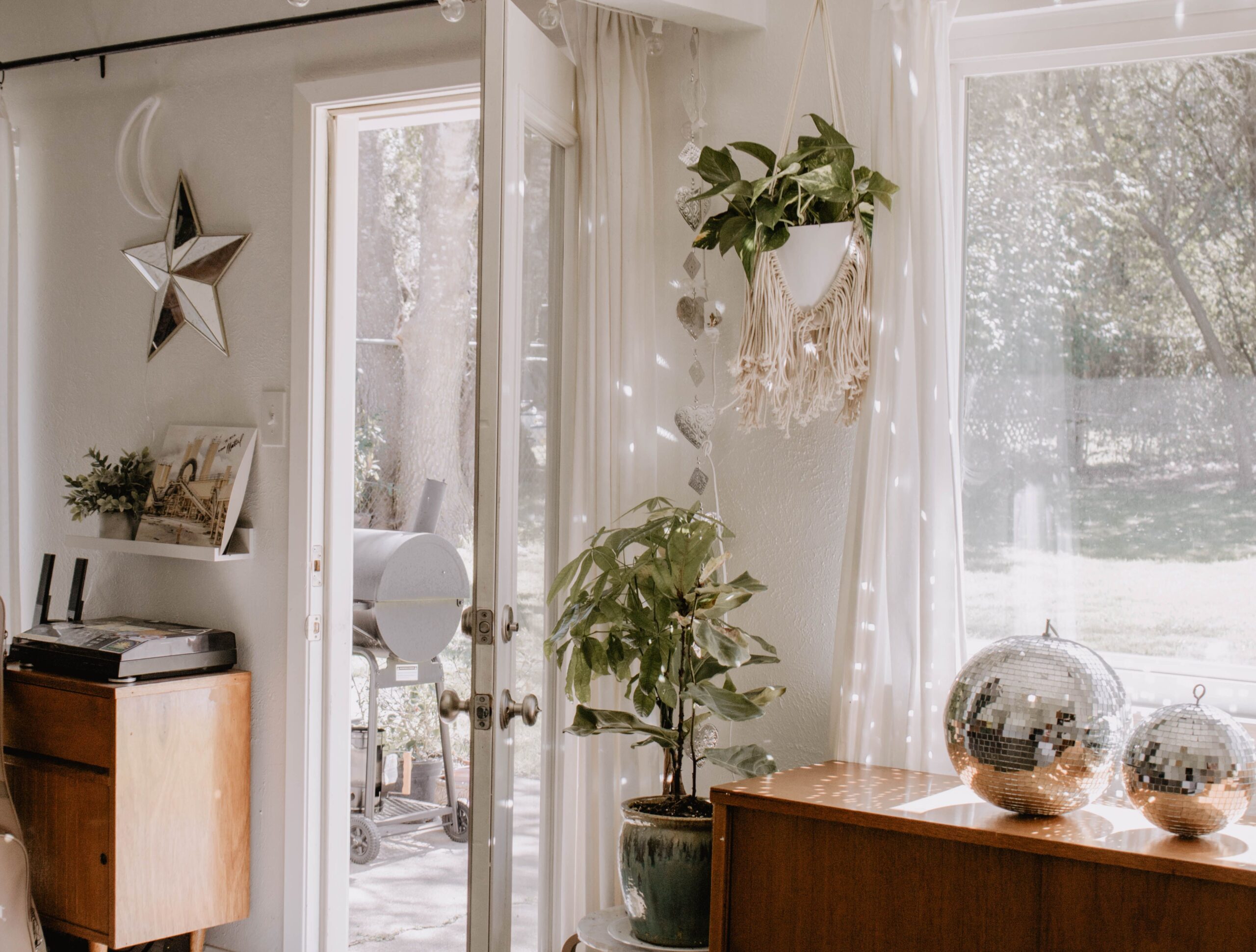 Relaxed boho reading nook with a cushioned chair, floor lamp, woven basket, rug, plant, and small table.