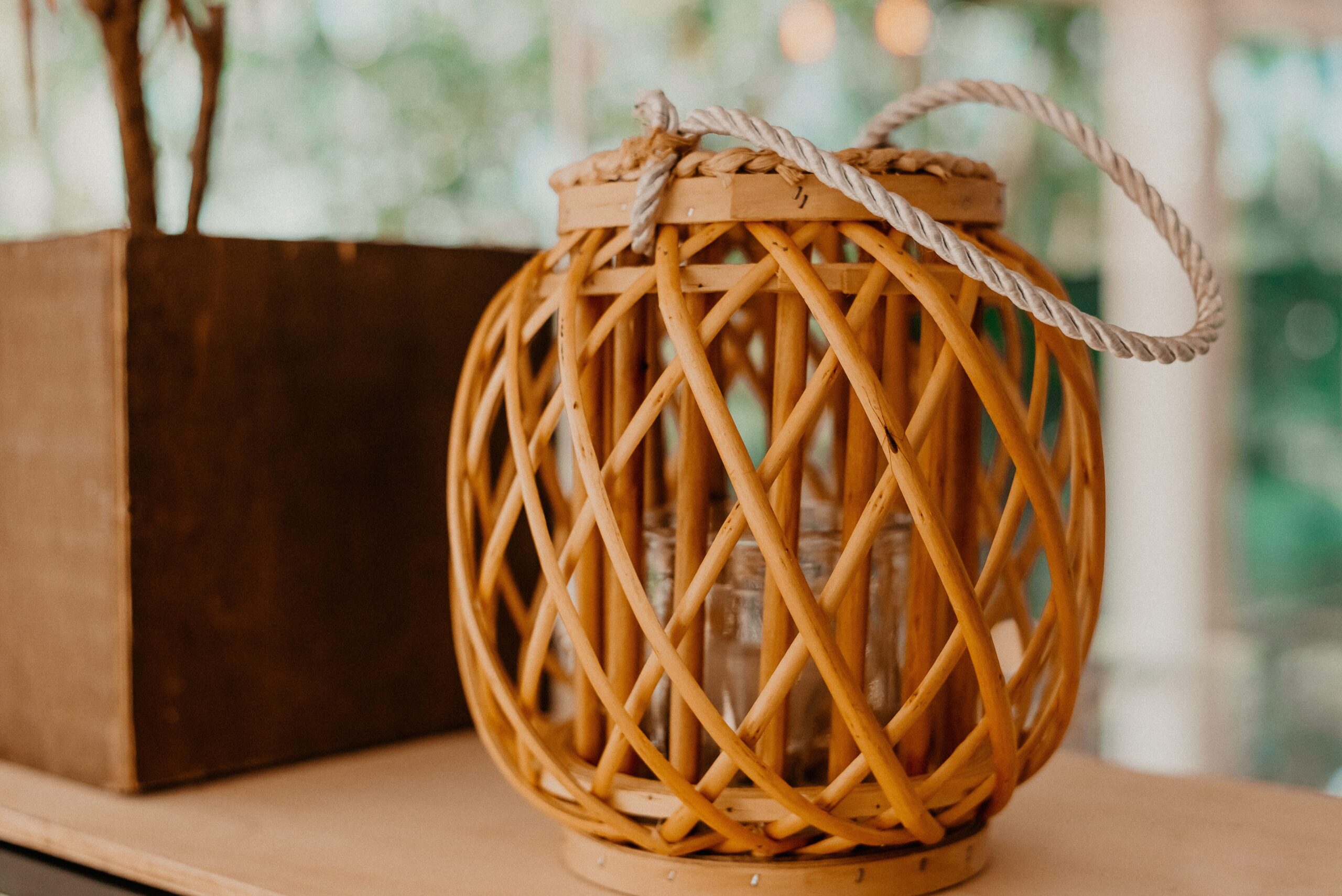 Boho seating area with jute and patterned rugs, woven baskets, rattan furniture, linen curtains and textured throws