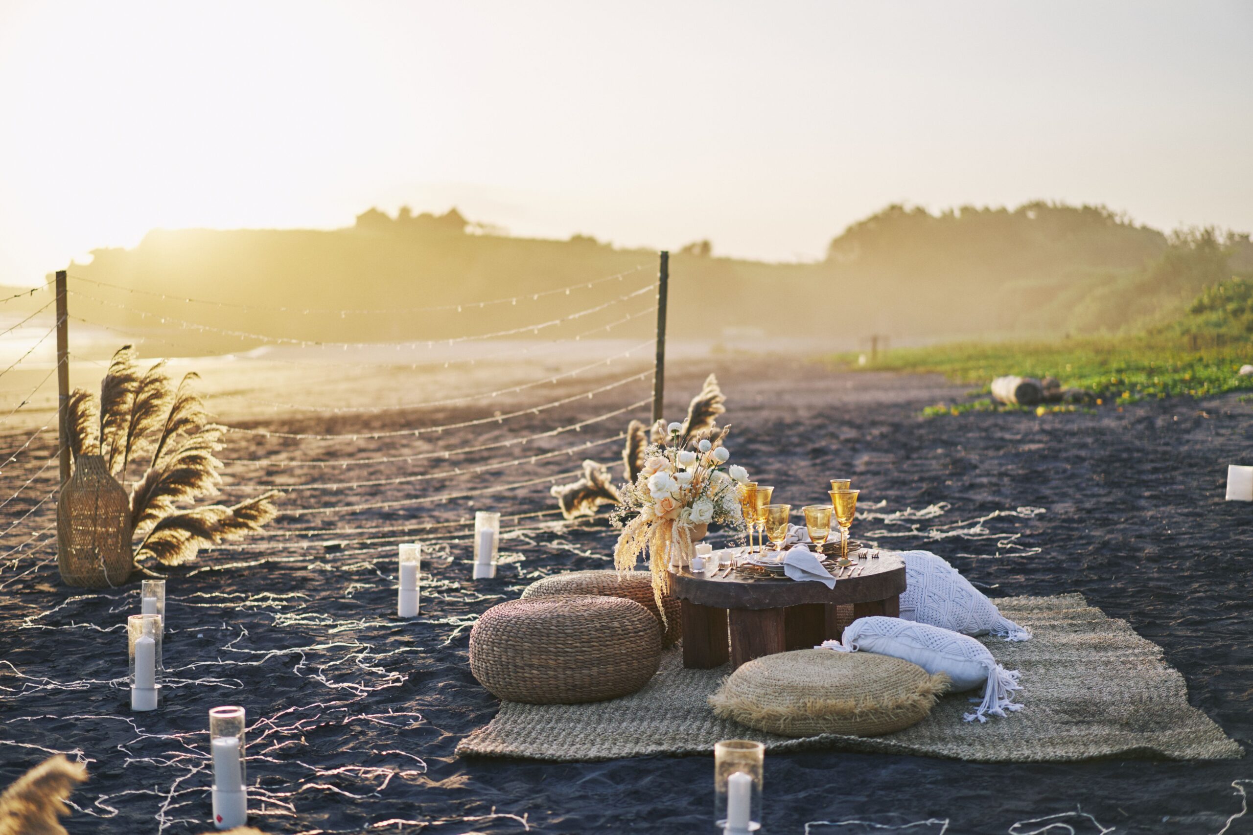 Conversation-focused bohemian seating arrangement with sofa, armchairs, floor cushions, and pouf