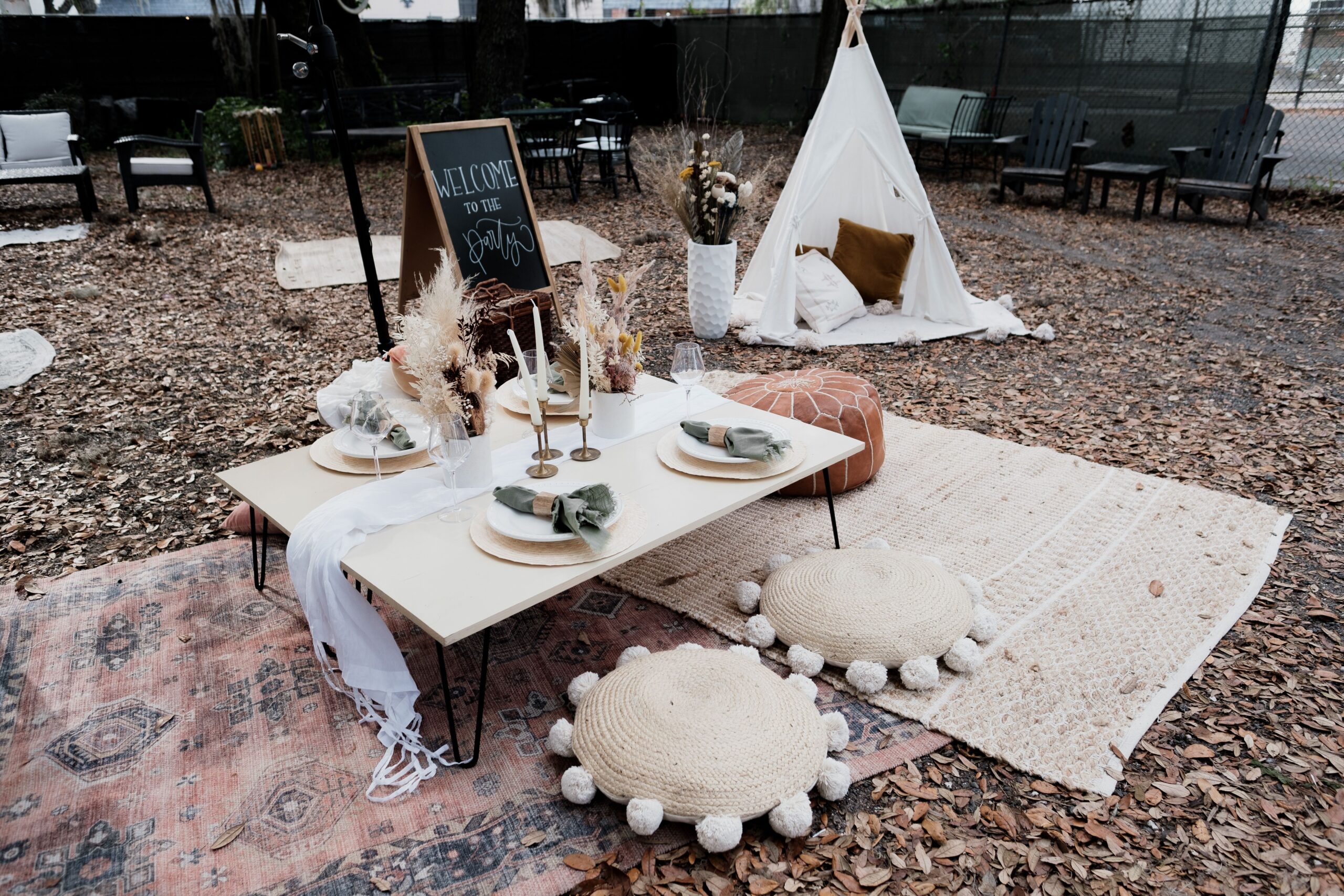 Warm bohemian living room with layered textiles, earthy colors, rattan furniture, plants and soft natural light