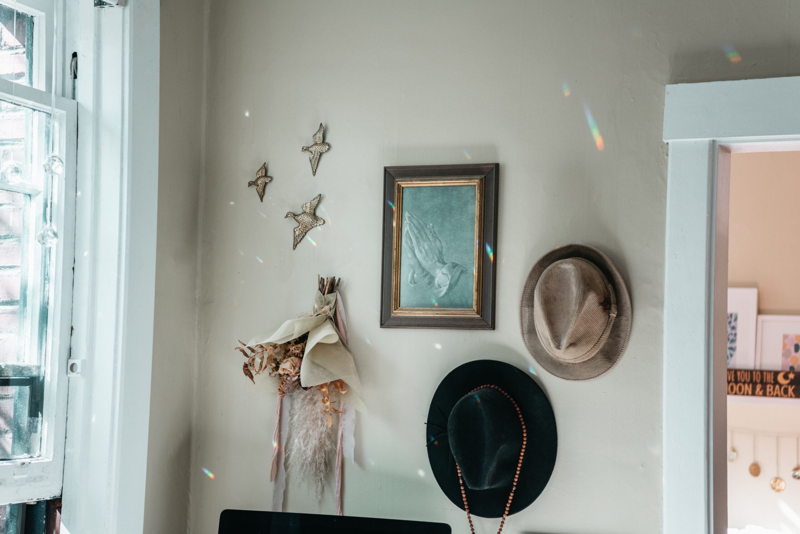 Boho room vignette featuring neutral furnishings and terracotta, olive and dusty rose accents