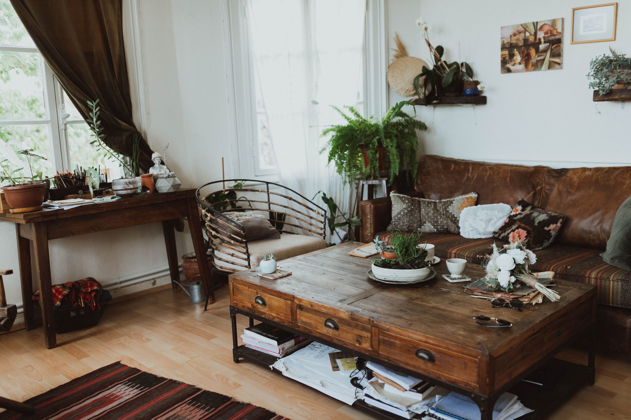 Boho shelves and coffee table styled with ceramics, books, framed art, plants and woven decor